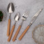 Nicolson Russell Acacia Light Wood Cutlery Set, 16-Piece on the table