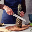 Tramontina Stainless Steel Bread Knife, 20cm slicing a pineapple