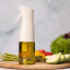 Zuutii Oil Sprayer, 170ml - Light Cream with olive oil on the table