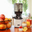 Kuvings Auto10 Cold Press Juicer - Pearl White on the table