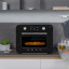 Smeg Retro Countertop Steam Oven - Glossy Black on the kitchen counter