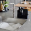 Zone Denmark Dishwashing Set with Cloth - Black next to the sink