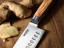 Wolstead Satoru Damascus Santoku Knife - 14cm on the table
