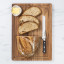 Wolstead Calibre Bread Knife, 20cm on a bread board with bread