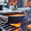 Joseph Joseph Space Ceramic Non-Stick Saute Pan with Glass Lid and Folding Handle, 28cm on the stove