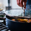 Joseph Joseph Space Ceramic Non-Stick Saute Pan with Glass Lid and Folding Handle, 28cm on the stove