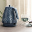 DeLonghi Ballerina Cordless Kettle, 1.7L - Sapphire with a cup of tea
