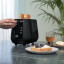 DeLonghi Eclettica 2-Slice Toaster - Black with toasted bread