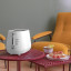 DeLonghi Eclettica 2-Slice Toaster - White on a coffee table