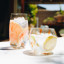 Ngwenya Glass Flecked Organic Highball Tumblers, Set of 4 - Orange on the table