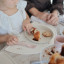 Mushie Silicone Placemat - Pink Flowers on the table