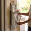 Joseph Joseph Swift Ironing Mat - Ecru Scatter hung on the door