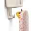 Joseph Joseph IronHub Wall-Mounted Ecru Iron Storage Caddy detail with an iron and ironing board