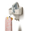 Joseph Joseph IronHub Wall-Mounted Ecru Iron Storage Caddy detail with an iron and ironing board