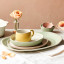 Jamie Oliver Big Love Stoneware Cosy Cuppa Mug, 375ml - Yellow on the table with a dinner set