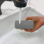Scrub Daddy Silver Damp Duster Sponge under running water