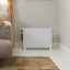 DeLonghi Slim Style Convector Heater with Fan, 2000W in the living room again the wall