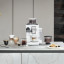 DeLonghi Rivelia Bean to Cup Coffee Machine with Bean Switch - Arctic White with coffee cups on the kitchen counter