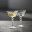 Lyngby Melodia Crystal Champagne Coupe Glasses, Set of 4 with champagne on the table