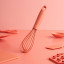Fusion Twist Silicone Whisk - Coral on the table
