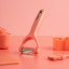 Fusion Twist Multi Peeler - Coral on the table
