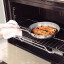 Tramontina Grano Stainless Steel Frying Pan - 20cm with food in an oven