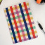 Kikkerland A5 Notebooks, Set of 3 on the table with a pen