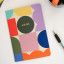 Kikkerland A5 Notebooks, Set of 3 on the table with a pen