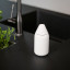 Zone Denmark Singles Soap Container - Grey next to a tap