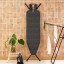 Brabantia Denim Black Ironing Board with Steam Iron Rest, 124cm x 38cm against a wall