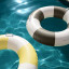 Sunnylife Slim Tube Pool Ring - Rustico Driftwood Stripe in the pool