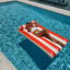 Sunnylife Luxe Lilo Float - Red Stripe in a pool