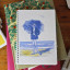 Growing Paper Girl On The Beach Notebook on the table with other books