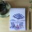 Growing Paper Beach Day Notepad with Momo Pencil on the table
