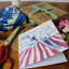 Growing Paper Dog On The Bed Greeting Card on the table