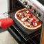 Lekue Silicone Rectangular Pizza Crisper Mat in an oven with pizza