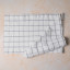 Mikasa Grey & White Industrial Check Table Runner, 230cm folded on a counter