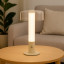 Arc & Hue Arcis Portable & Rechargeable LED Lamp - Cream on a coffee table