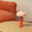 Arc & Hue Poppy Portable & Rechargeable LED Lamp - Pink on a coffee table
