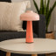 Arc & Hue Poppy Portable & Rechargeable LED Lamp - Pink on a coffee table