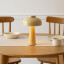 Arc & Hue Poppy Portable & Rechargeable LED Lamp - Mustard on a dinner table