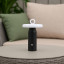 Arc & Hue Ella Portable & Rechargeable LED Outdoor Lamp - Black on a coffee table
