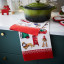 Ulster Weavers Merry Mutts Cotton Tea Towel on the table with a pot