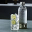 Sodastream Enso Carbonating Bottle, 1L on the kitchen island with a glass of sparkling water
