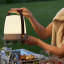 Kooduu Lite-Up Play Mini JBL Speaker & Lamp - White/Earth on a dinner table