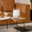 Kooduu Lite-Up Play Mini JBL Speaker & Lamp - White/Sand on a coffee table