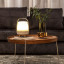 Kooduu Lite-Up Play Mini JBL Speaker & Lamp - White/Sand on a coffee table
