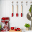 KitchenAid Birchwood Basting Brush hung with other utensils on the kitchen hanger