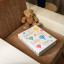 Printworks Dream Big Little One Baby Album - Beige next to a teddy bear