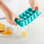 Lekue Dolphin-Shaped Ice Cube Tray with Lid with ice in a glass